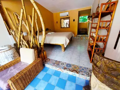 a bedroom with a bed and bunk beds in it at Baan sikhao Yanui in Rawai Beach