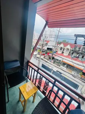 a balcony with a table and a view of a street at Royal Vista Patong in Patong Beach