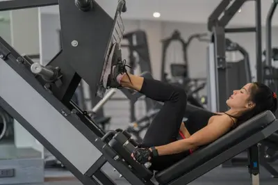 a woman laying on a machine in a gym at Kamala Beach P72 Exclusive Junior Suite in Phuket Town