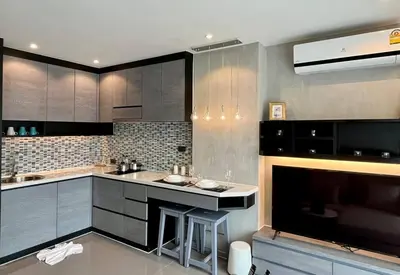 a kitchen with gray cabinets and a counter top at Kamala Beach P72 Exclusive Junior Suite in Phuket Town
