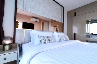 a bedroom with a large white bed with a large headboard at A402-Silk Condo Aonang-Sea view-5 mins walk to beach in Ao Nang Beach