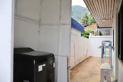 a room with a white wall and a building at Kamala - Chonlada Holiday Home 2 BR Residence in Kamala Beach