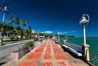 a sidewalk next to a road next to the water at Pixel Condo - Panwa Beach in Ban Ao Makham