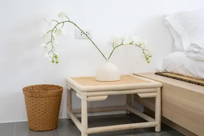 a table with a vase on it next to a bed at Villa Sunrise Garden A180 in Thalang