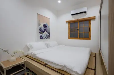 a bedroom with a white bed and a window at Villa Sunrise Garden A180 in Thalang