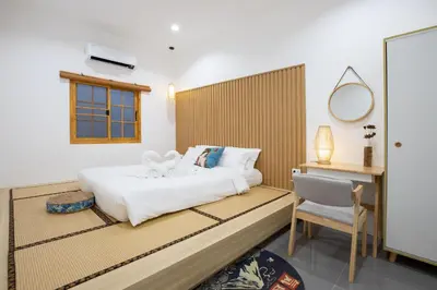 a bedroom with a bed and a desk and a chair at Villa Sunrise Garden A180 in Thalang
