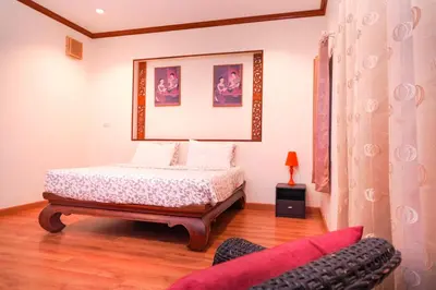 a bedroom with a bed and a couch at Guesthouse Phuket Airport in Ban Bo Han