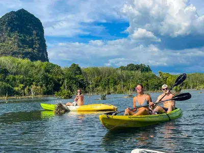 three people are sitting in kayaks on the water at Nomads Ao Nang Party Hostel 18-35 Years Old Only in Ao Nang Beach