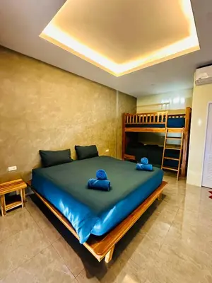 a bedroom with a large bed with two blue towels on it at Kohyao Non Bay in Ko Yao Yai