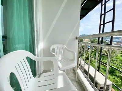 two white chairs on a balcony with a view at Patong Platinum in Patong Beach