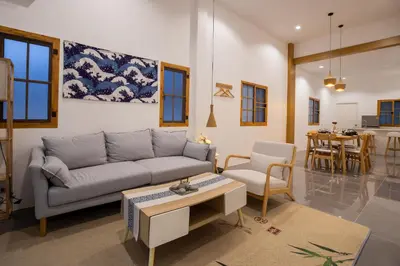 a living room with a couch and a table at Villa Sunrise Garden B191 in Thalang