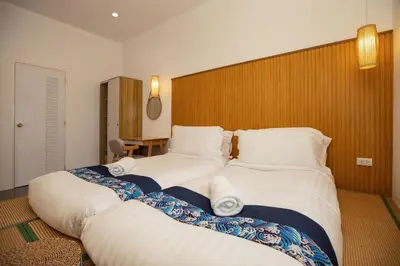 a bedroom with a large bed with white pillows at Villa Sunrise Garden B191 in Thalang