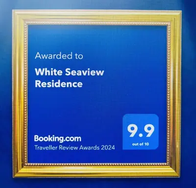 a framed picture of a white savoy residence at White Seaview Residence in Klong Muang Beach