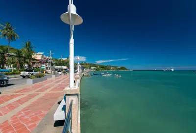 a street light next to the water with boats in it at Pixels - Ocean Front Studio with Pool View Cape Panwa in Ban Ao Makham