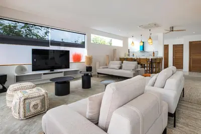 a living room with white furniture and a flat screen tv at New & Elegant 5Br Pool Villa Samakki Garden 5 in Rawai Beach