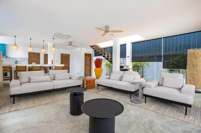 a living room with white couches and a table at New & Elegant 5Br Pool Villa Samakki Garden 5 in Rawai Beach