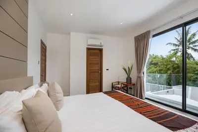 a bedroom with a bed and a large window at New & Elegant 5Br Pool Villa Samakki Garden 5 in Rawai Beach