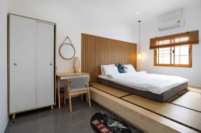 a bedroom with a bed and a desk and a chair at Villa Sunrise Garden A181 in Thalang