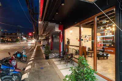 a restaurant with motorcycles parked outside of a building at The Dorm Hostel in Ban Lo Long