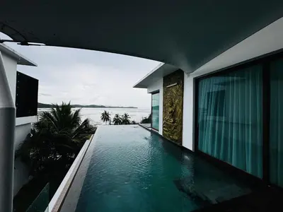 a swimming pool in a house with a view of the ocean at Sunrise Ocean Villa 20 in Phuket Town