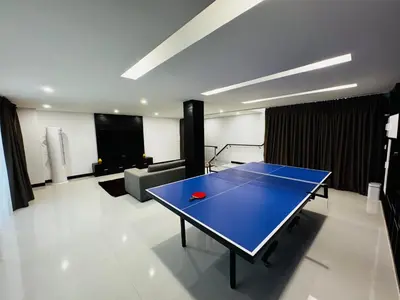 a ping pong table in the middle of a room at Sunrise Ocean Villa 20 in Phuket Town
