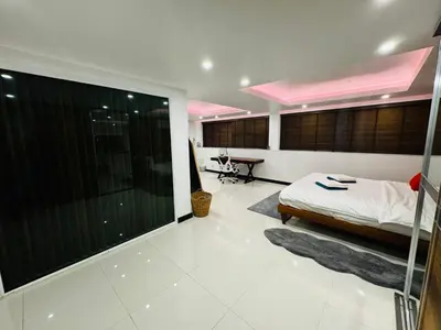 a bedroom with a bed and a large window at The Sunrise Ocean Villa 22 in Phuket Town