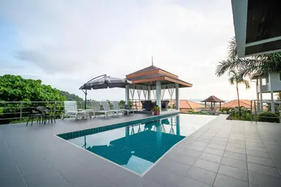 a swimming pool with a gazebo on a house at ฺBaan Waru seaview villa in Kata Beach