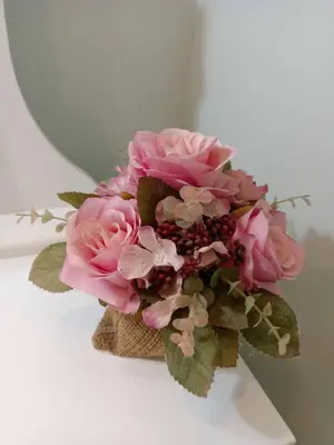a bouquet of pink flowers sitting on a table at 168Hostel Airport@Phuket in Thalang