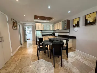 a kitchen with a black table and chairs at Bel Air Cape Panwa resort apartment in south Phuket with pool access ,near Ao Yon in Phuket Town