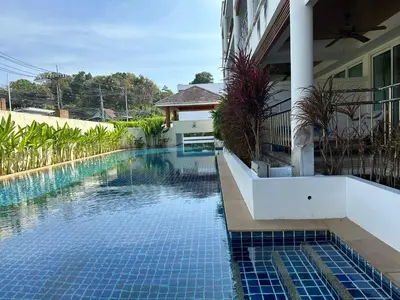 a swimming pool next to a house at Bel Air Cape Panwa resort apartment in south Phuket with pool access ,near Ao Yon in Phuket Town