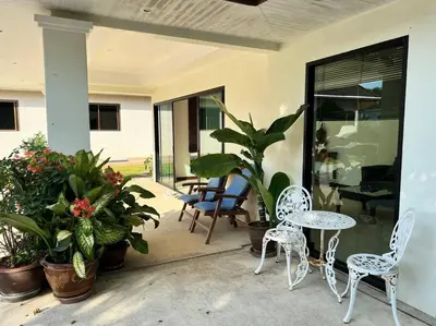 a patio with a table and chairs and plants at Maya Villa by G Estate in Rawai Beach