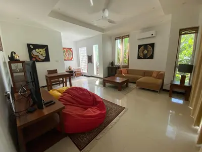 a living room with a couch and a tv in it at Seaview Prima Villa Karon beach in Karon Beach
