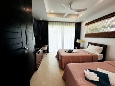 a hotel room with two beds and a window at Seaview Prima Villa Karon beach in Karon Beach