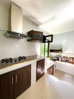 a large kitchen with a stove and a sink at Sea Smile Green View Pool Villa KRABI Klong Muang in Klong Muang Beach