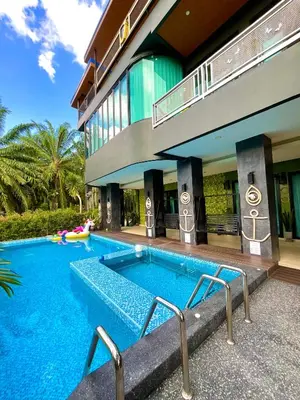 a swimming pool in front of a building at Sea Smile Green View Pool Villa KRABI Klong Muang in Klong Muang Beach