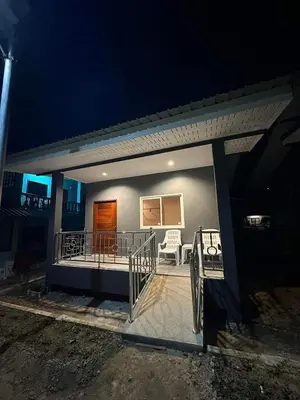 a small house with a balcony at night at PP. Valentine Bungalow in Phi Phi Don