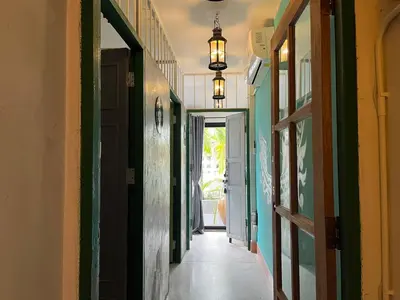 an empty hallway with green and yellow walls at Auntie & Niece PHUKET in Ban Sam Kong