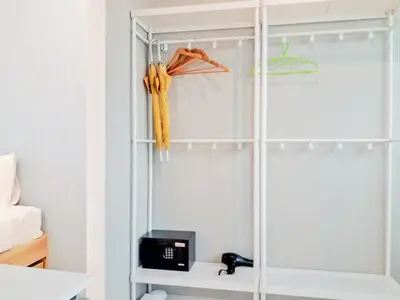 a room with a closet with a glass door at Kata Forte Resort in Kata Beach