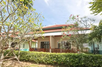 a house with a red roof and some bushes at Kata Forte Resort in Kata Beach