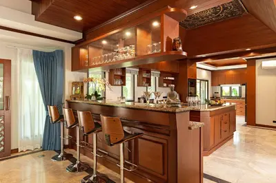 a bar with stools in a room with wood at Villa Carlos, Luxury 7 BDR Private Pool Villa, Baan Bua Nai Harn, Phuket in Rawai Beach