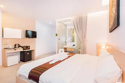 a bedroom with a large white bed in a room at My Hotel Phuket in Patong Beach
