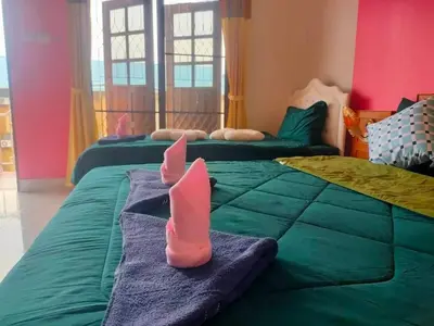a bedroom with two beds with pink socks on them at Pailin Hill Hotel in Patong Beach