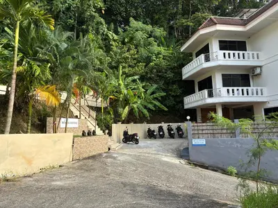 a group of motorcycles parked in front of a house at Riviera Patong in Patong Beach