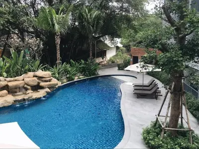 a swimming pool with a bench and an umbrella at А2 ВАТСАП669З582I976 примем РУБЛИ in Nai Yang Beach