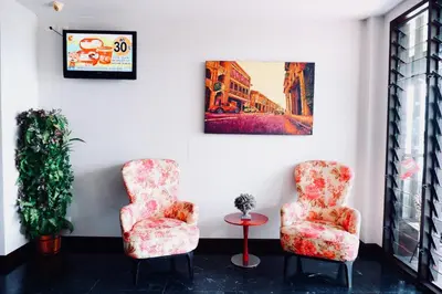 two chairs and a table in a room at Ratana Residence Thalang in Thalang