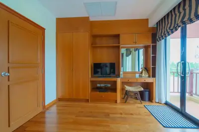 a room with a door and a desk with a television at 3-4BR Laguna Phuket Golf Course Villa with Pool & Jacuzzi in Laguna Phuket
