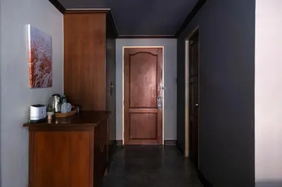 a hallway with a wooden door in a room at Grand Orlov Apart Hotel in Patong Beach