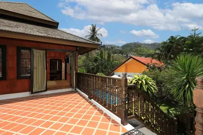 a balcony of a house with a fence at WoLin Lemon Resort in Ban Saiyuan (1)