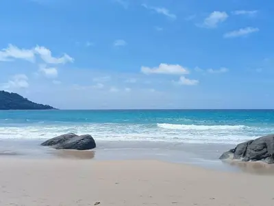 a beach with rocks in the sand and the ocean at Katamanda villa Moon 3 Bed seaview near Kata Beach in Kata Beach