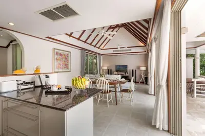 a kitchen and living room with a table and chairs at Katamanda 3 Bed Tropical Villa B3 Near Kata Beach in Kata Beach
